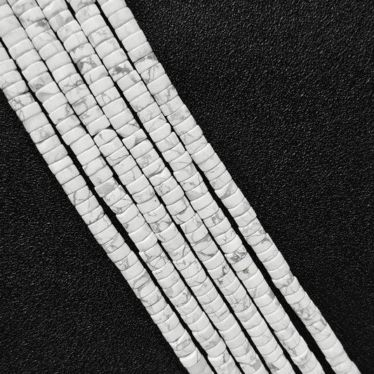 Macro closeup of natural white howlite heishi rondelle beads 6x3mm showing black webbed matrix