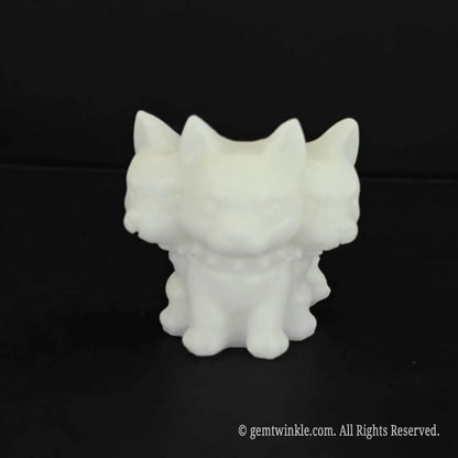 A standalone front view of a 4.5cm cute white marble Cerberus figurine with an oversized three headed puppy design and spiked collar