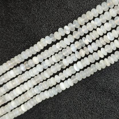 Macro closeup of natural white moonstone smooth rondelle beads 6x4mm showing translucent milky sheen