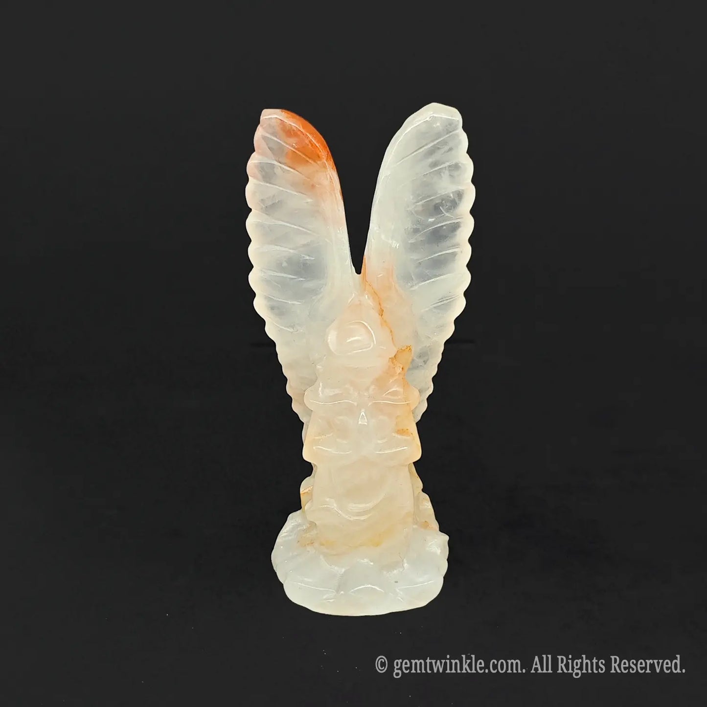 Semi translucent white quartz guardian angel statue displaying organic internal cloudy phantom veils