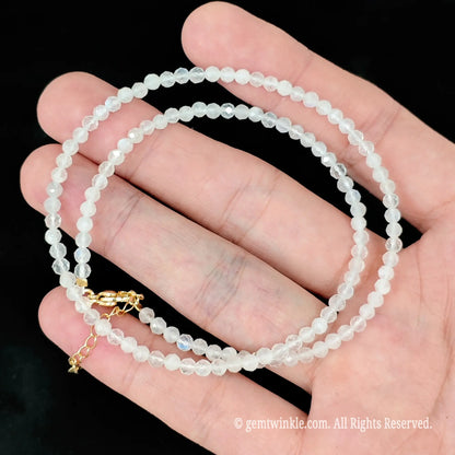 faceted white moonstone micro bead necklace loop with gold extender chain on hand