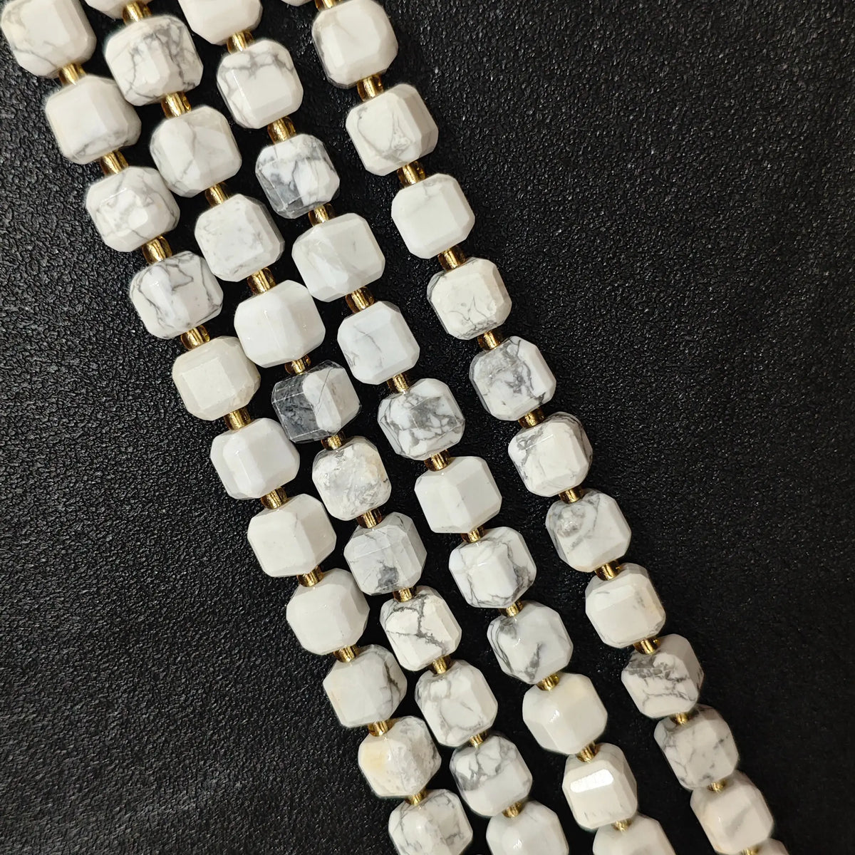 Full strands of natural white turquoise square block beads featuring dark web matrix patterns for wholesale buyers
