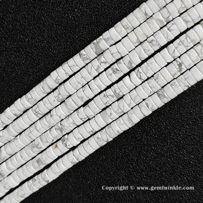 Perspective view of natural white howlite heishi spacer beads showing uniform 3mm thickness