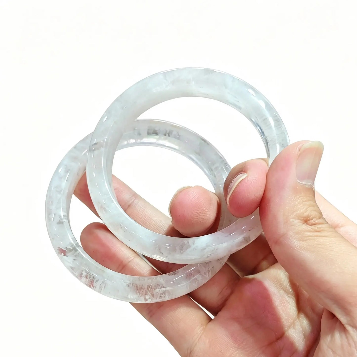 Natural white phantom quartz bangle bracelet showing clear crystal body and snowy phantom inclusions