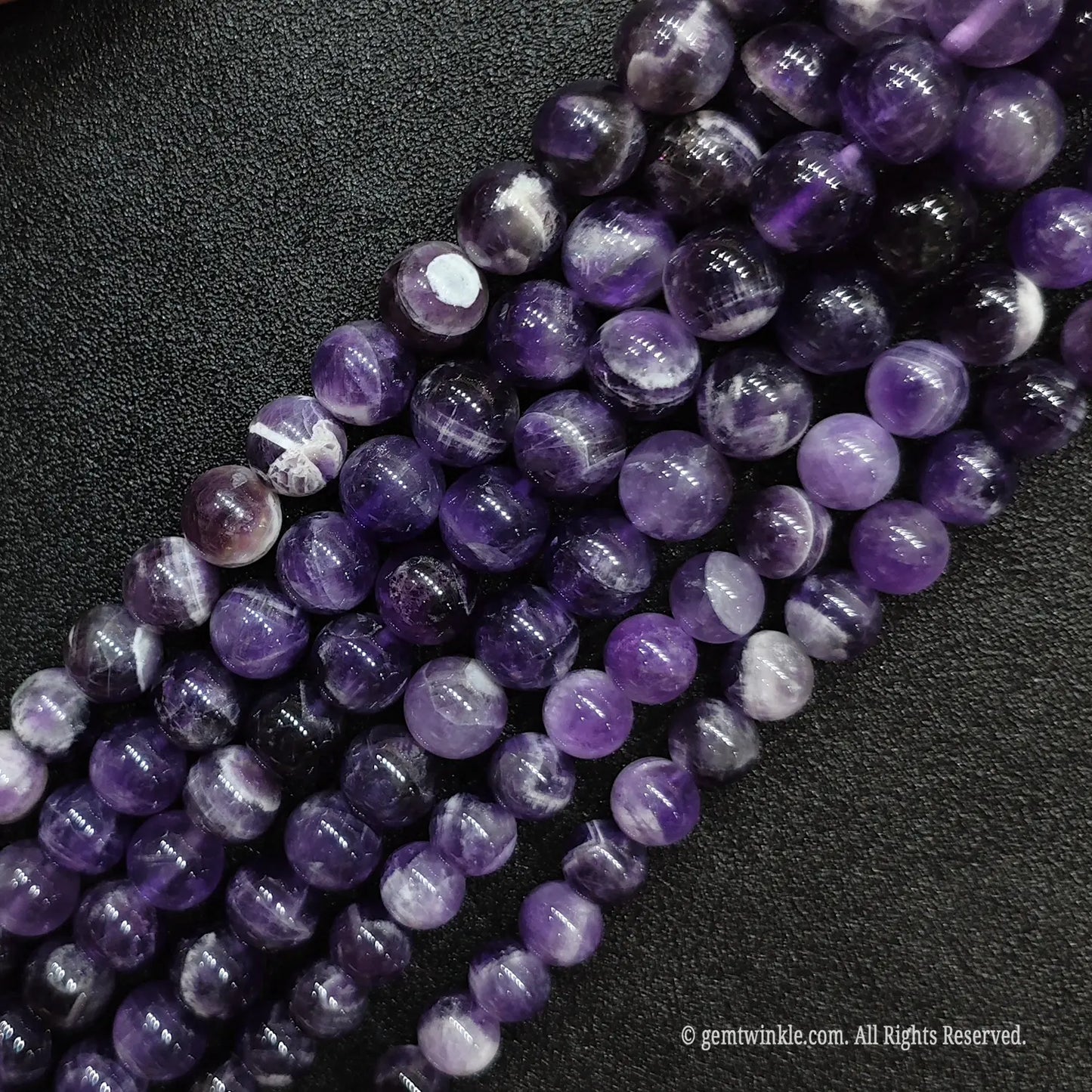 High polish wholesale dream amethyst quartz loose beads strands positioned diagonally for artisan jewelry designers