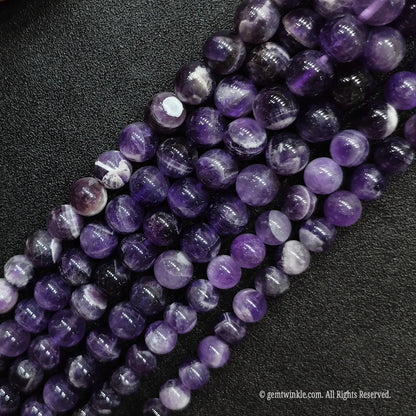 High polish wholesale dream amethyst quartz loose beads strands positioned diagonally for artisan jewelry designers