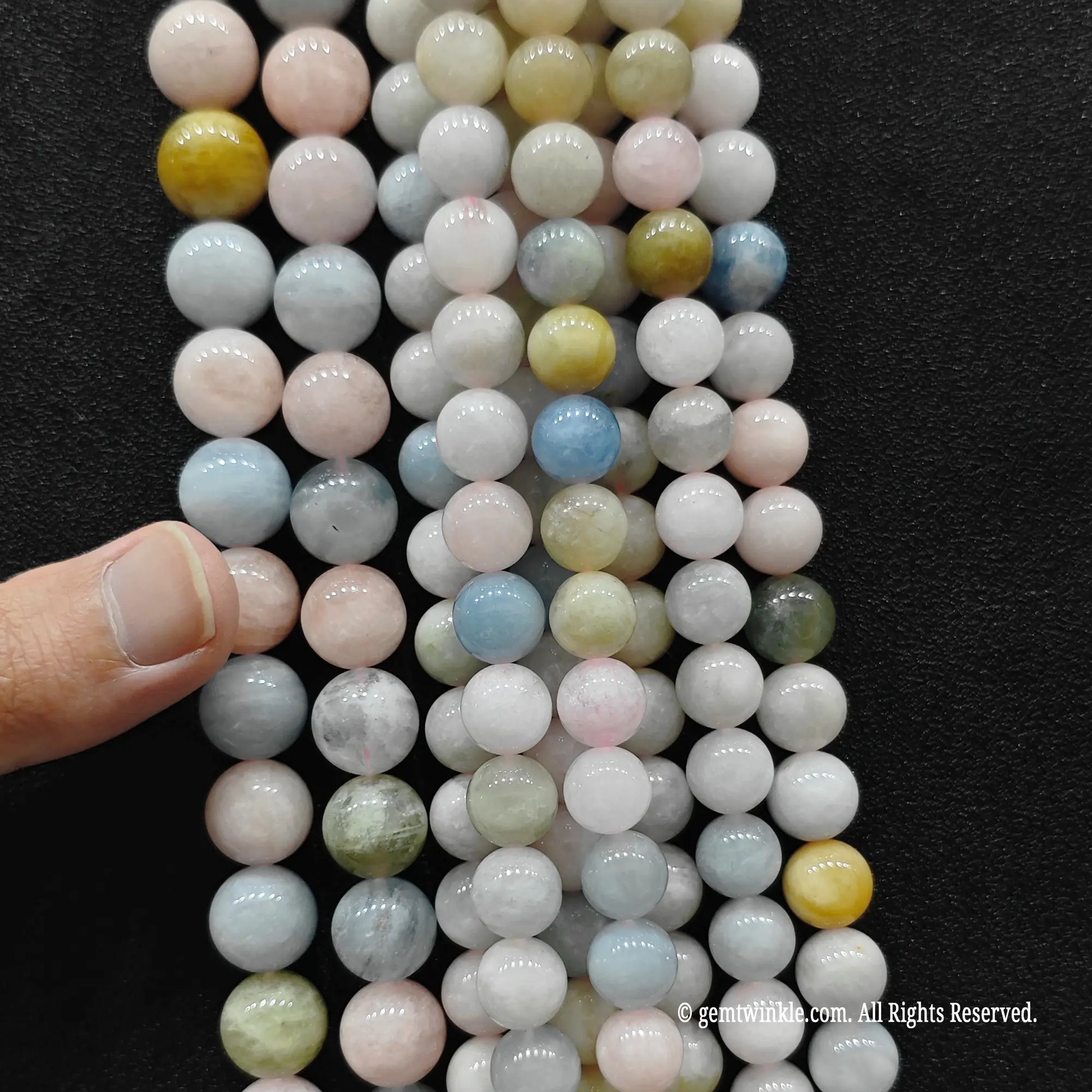 Multiple strands of wholesale pastel opaque multi color morganite crystal beads showing the B minus grade structural distribution and size comparison from image_cc95a3.jpg