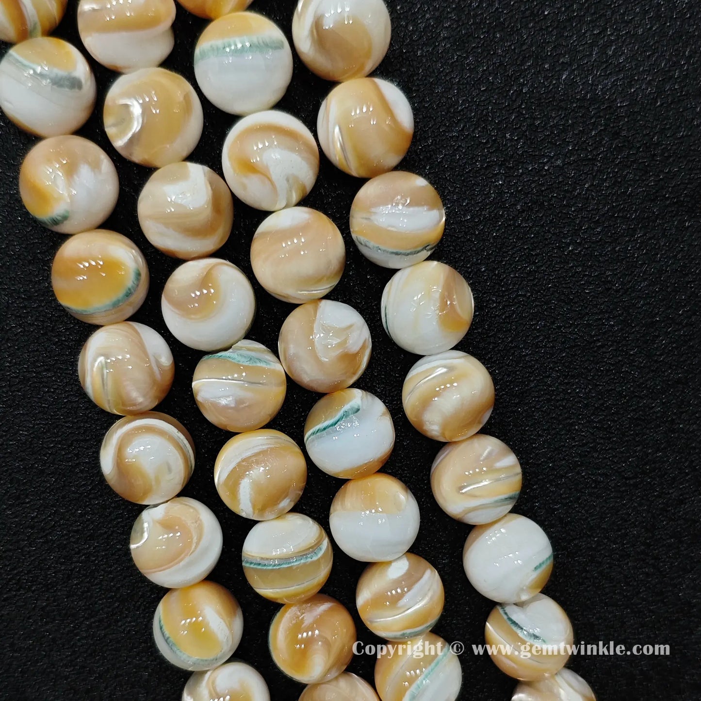Bulk warehouse display of real un-dyed natural marine shell round beads perfect for substantial handmade bohemian jewelry and statement designs