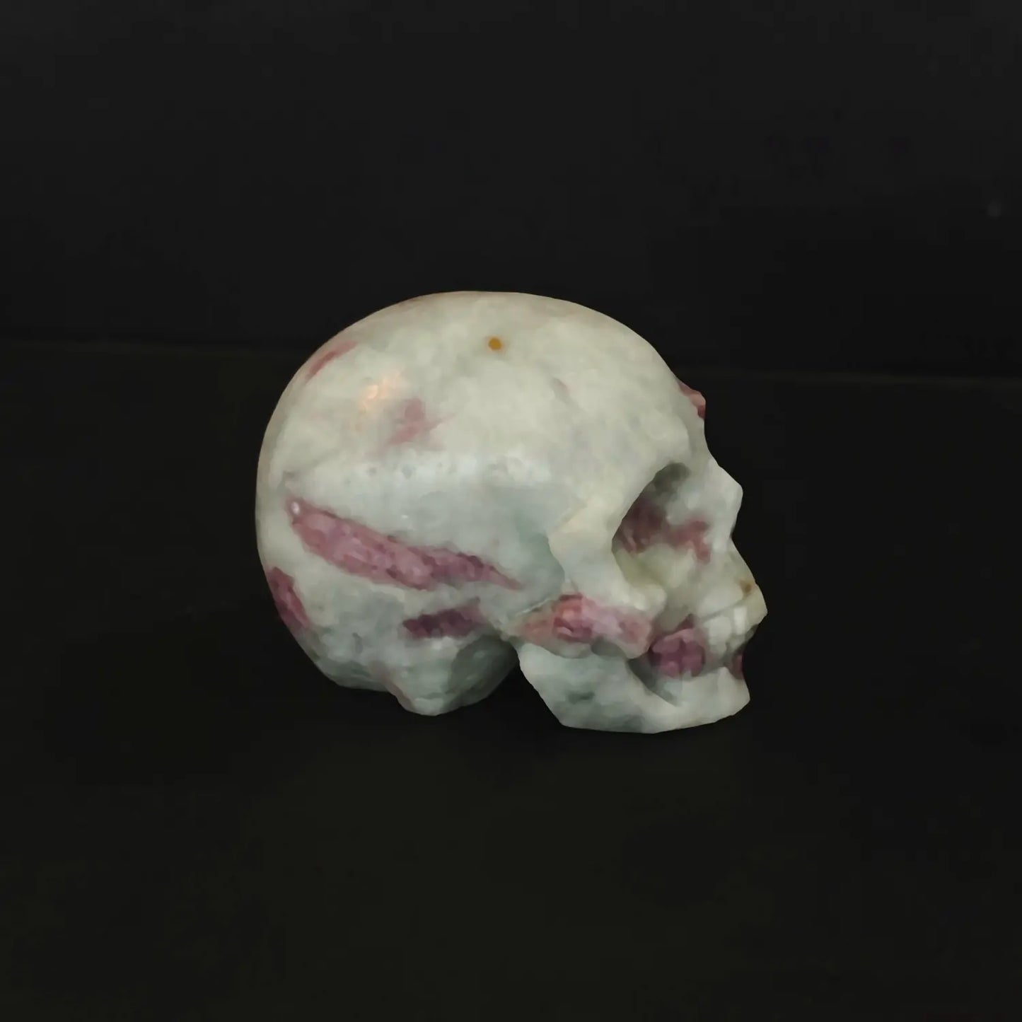 Two natural pink tourmaline in quartz human crystal skull carvings with gothic details as shown in image_293c09.jpg