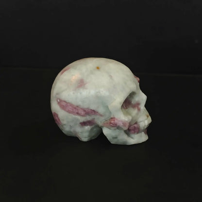Two natural pink tourmaline in quartz human crystal skull carvings with gothic details as shown in image_293c09.jpg