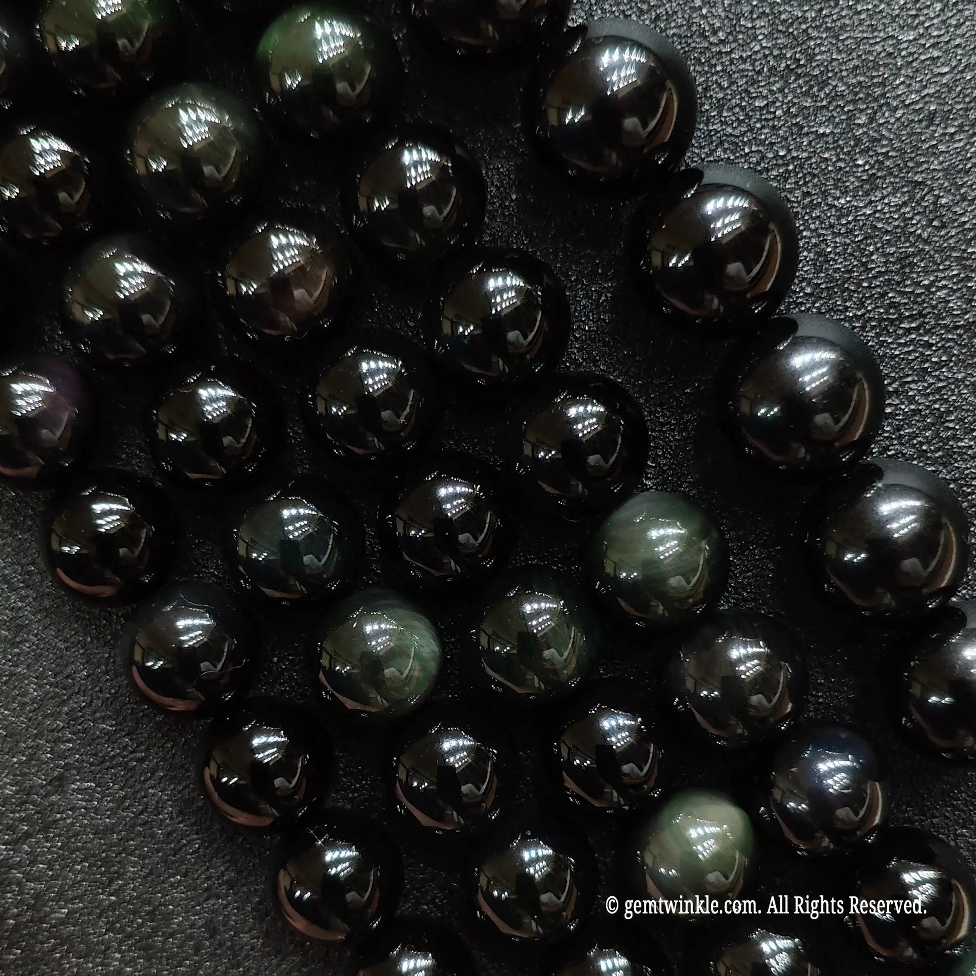 A grid collection of natural rainbow obsidian crystal beads strands from 4mm to 18mm for custom jewelry making