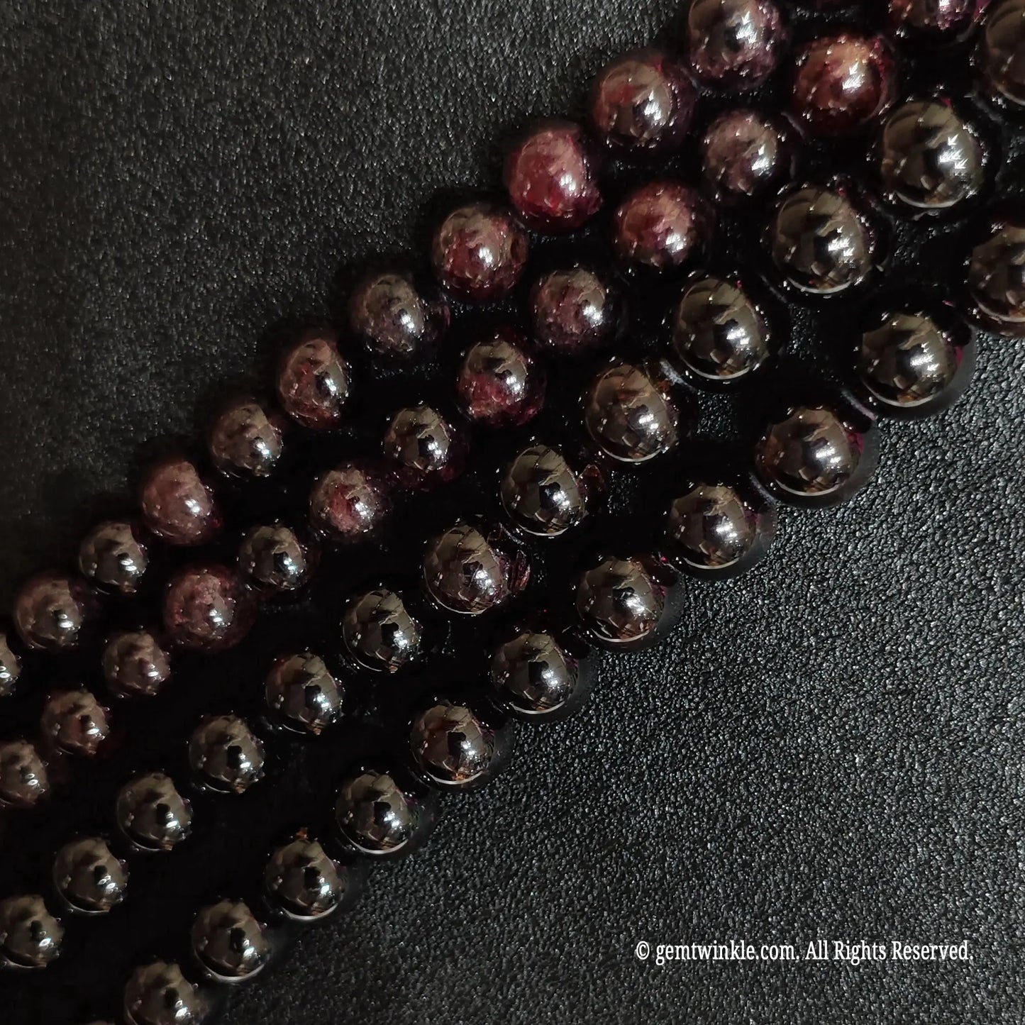 diagonal layout of dark opaque natural garnet crystal strands