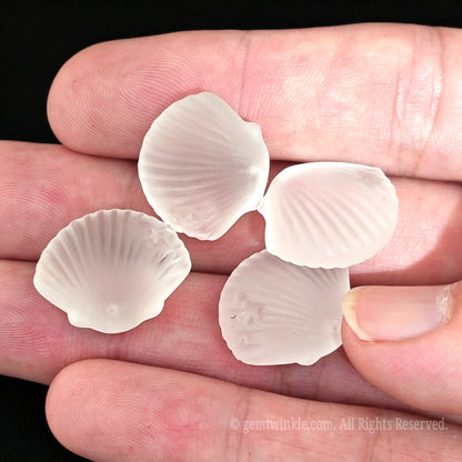 three frosted crystal seashell beads arranged for crafting