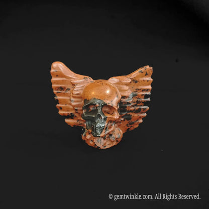 Handheld red obsidian stone winged skull carving