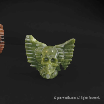 Close up front view of serpentine winged skull statue