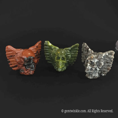 Trio set of winged skull carvings in natural stone