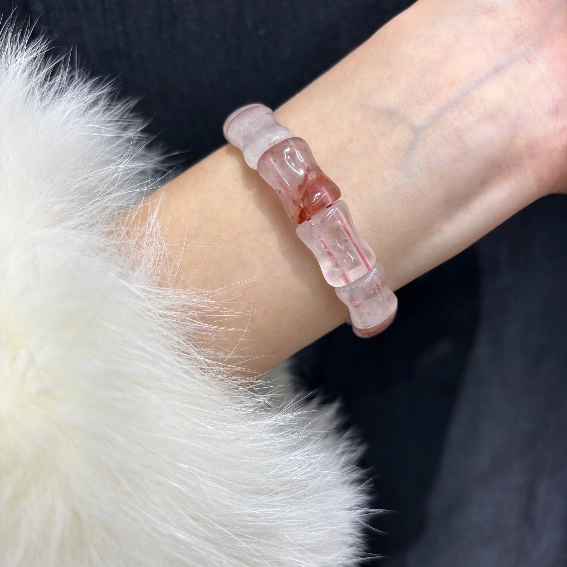 Woman wearing a natural red quartz bamboo bead bracelet on her wrist.