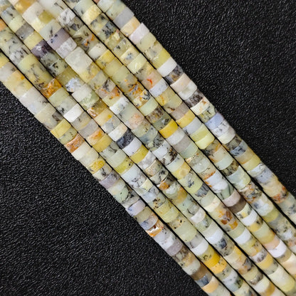 Macro closeup of natural yellow australian opal heishi rondelle beads 6x3mm showing honey tones