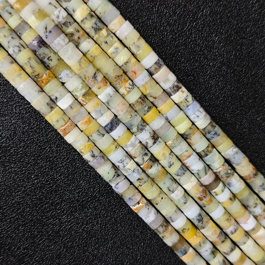 Macro closeup of natural yellow australian opal heishi rondelle beads 6x3mm showing honey tones