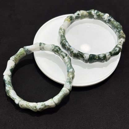 Detailed view of the yellow and blue tiger eye cylinder bead bracelet, focusing on the texture and color variations of the natural stone.