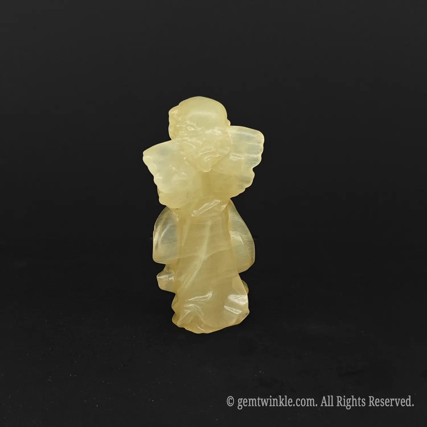 Back view of a natural yellow calcite praying angel carving showing its beautifully polished wing structure, perfect for abundance crystal gifts