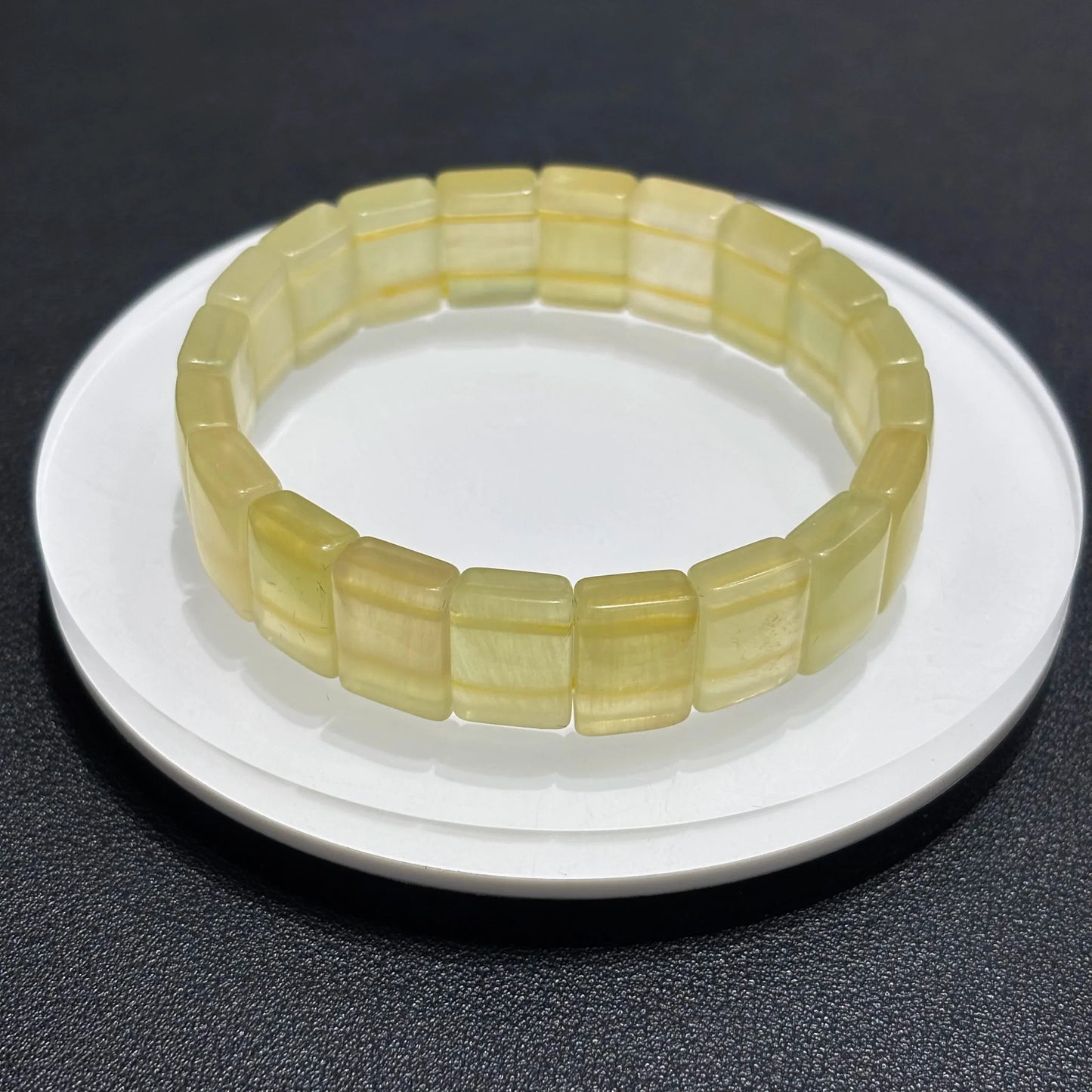 Close-up of Natural Yellow Fluorite Bangle Bracelet, showing the translucent quality and color variations of the stone.