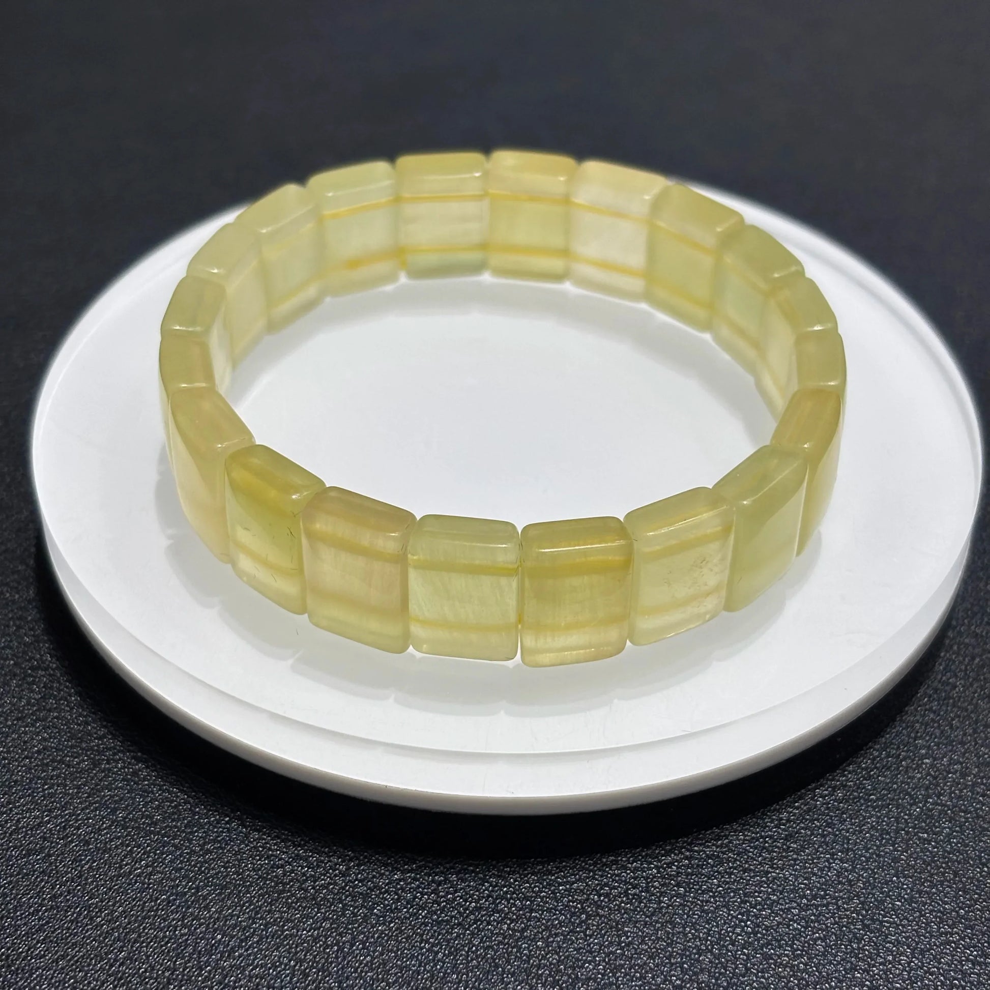 Close-up of Natural Yellow Fluorite Bangle Bracelet, showing the translucent quality and color variations of the stone.