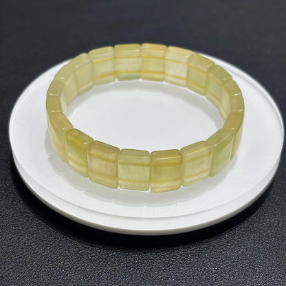 Close-up of Natural Yellow Fluorite Bangle Bracelet, showing the translucent quality and color variations of the stone.