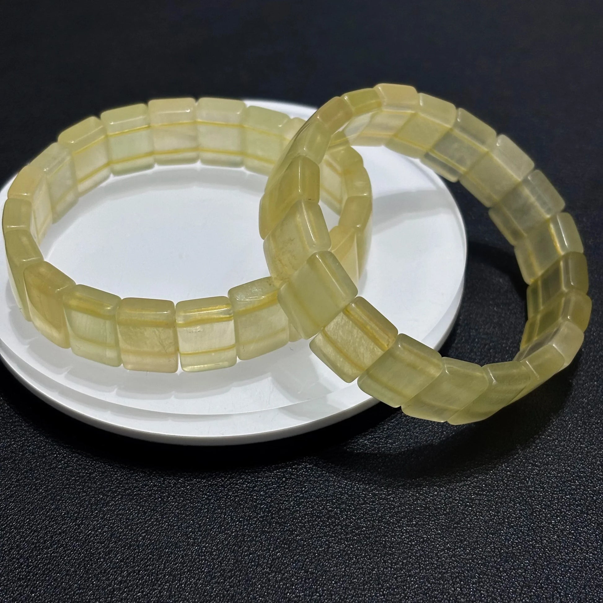 Side view of two Natural Yellow Fluorite Bangle Bracelets, highlighting the thickness and craftsmanship of the square beads.