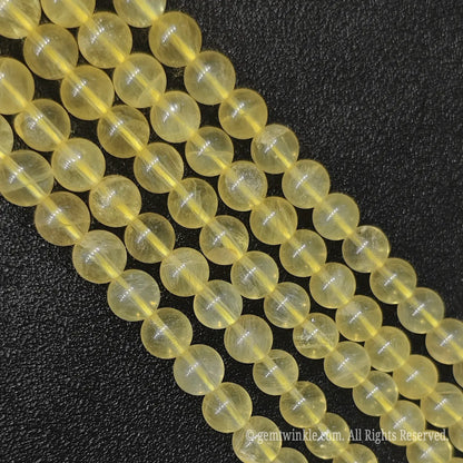 Multiple strands of natural yellow fluorite loose gemstone beads from Donghai crystal market showing rich honey-yellow transparency