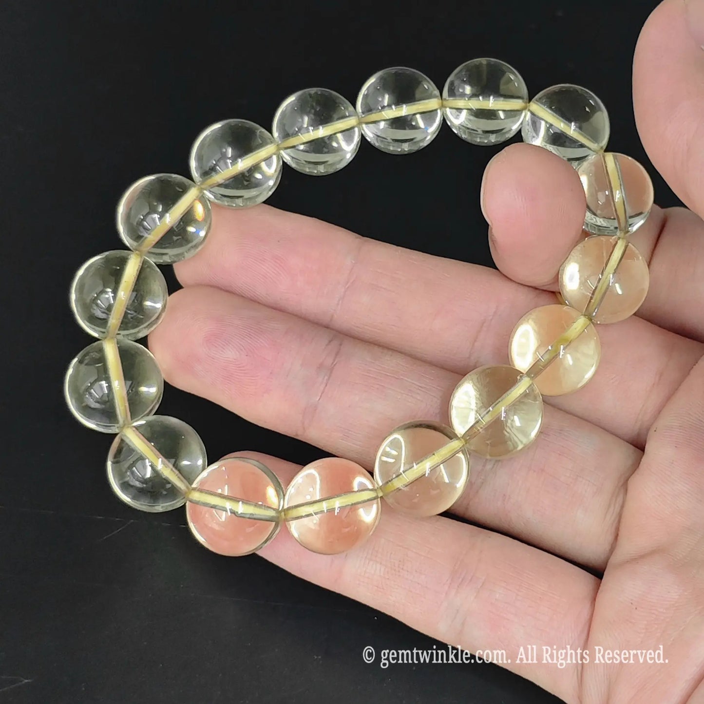 top view of translucent yellow lemon quartz stretch bangle on hand
