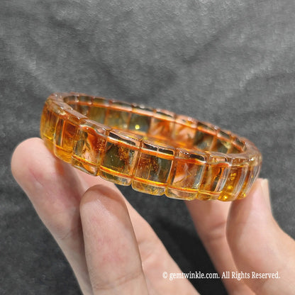 Close up view of yellow phantom quartz rectangular bead cuff displaying polished edges and golden transparency