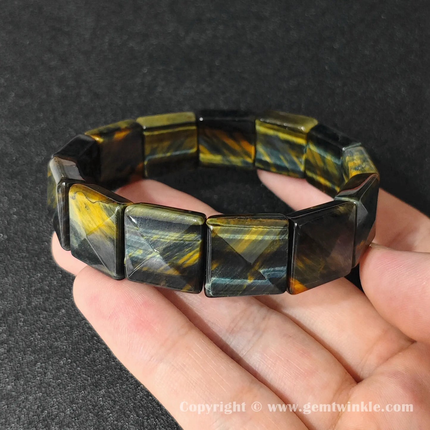 natural yellow blue tigers eye square plate bracelet displayed over hand showing glossy facets