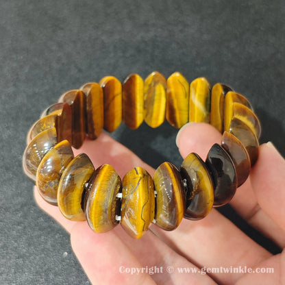 side profile view of machine polished golden yellow tigers eye crescent bead bracelet