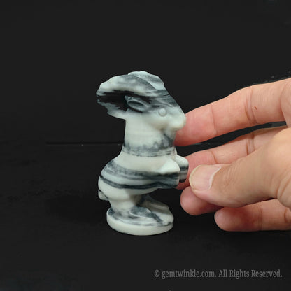 Side view of a 7cm black and white zebra jasper ram statue highlighting bold monochromatic patterns