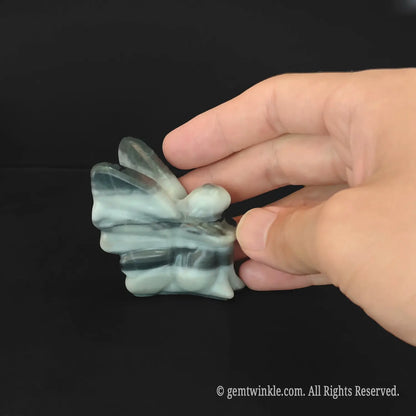 Back details of carved zebra stripe stone flower fairy showing swirling black and white patterns